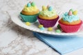 Three colorful easter cupcakes with chocolate mini eggs Royalty Free Stock Photo