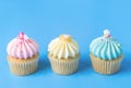Three colorful fancy cupcake on blue Royalty Free Stock Photo
