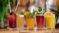 Three colorful fresh fruit and vegetable smoothies in glasses with straws on bar counter Royalty Free Stock Photo