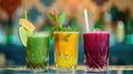 Three colorful fresh fruit and vegetable smoothies in glasses with straws on bar counter Royalty Free Stock Photo