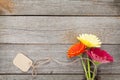 Three colorful gerbera flowers with tag Royalty Free Stock Photo