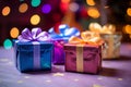 three colorful gift boxes on a table with a christmas tree in the background Royalty Free Stock Photo