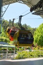 Three colorful gondolas cable cars as they transport people up and down in the Caracol Park