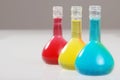 Three colorful laboratory flasks