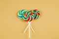 Three colorful lollipops on orange background Royalty Free Stock Photo