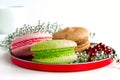 Three colorful macaroons on round plate Royalty Free Stock Photo
