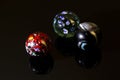 Three colorful marbles in a closeup photography Royalty Free Stock Photo