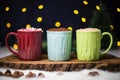 three colorful mugs filled with hot chocolate in a row Royalty Free Stock Photo