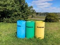 Three colorful outdoor recycling bins with inscriptions in Spanish lenguage. Royalty Free Stock Photo