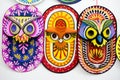Three colorful owl masks hanging on Art institute wall.