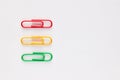 Three colorful paper clips in a row on white background Royalty Free Stock Photo
