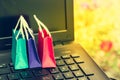 Three colorful paper shopping bags on laptop keyboard. Ideas about online shopping. e-commerce or electronic commerce is