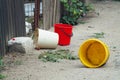 Three colorful plastic buckets thrown on the ground