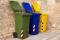 Three colorful recycling bins