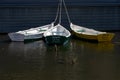 Three colorful rowboats moored in the harbor of Lunenburg