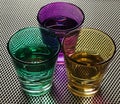 Three colorful shot glasses on a grid Royalty Free Stock Photo