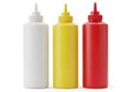 Three squeeze bottles for condiments including ketchup mustard and mayonnaise isolated on white background Royalty Free Stock Photo