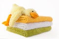 Three colorful towels with yellow plush duck Royalty Free Stock Photo