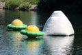 Three colorful white and yellow with green inflatable floating climbing walls in different shapes and sizes Royalty Free Stock Photo