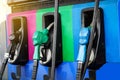 Three colors of fuel nozzle at gas station. Royalty Free Stock Photo