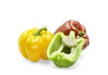 Three colors sweet bell pepper on white isolated background with clipping path. Yellow, green with cut a half and red sweet bell Royalty Free Stock Photo