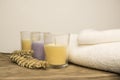 Three coloured candles with white towels