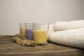 Three coloured candles with white towels