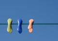 Three coloured cloths pegs in line Royalty Free Stock Photo