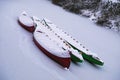 Three coloured and snow-covered boats lying on the frozen canal in Leipzig