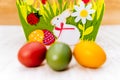 Three colourful blurred Easter eggs in front of decorative felt basket