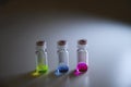 Three colourful solution in different LCMS glass vial on a white bench withshadow for medicinal chemistry research Royalty Free Stock Photo