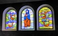 Three colourful stained glass windows