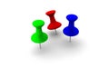 Three colourful thumbtacks in red, green and blue