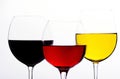 Three colours of drinks in wine glasses