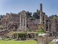 Three columns of the Dioscouroi temple and Domus Tiberiana in the Roman forum.