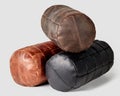 Three comfortable leather bolster cushions in different colors