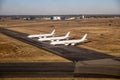Three commercial long-range passenger jet aircraft in the runway parking lot