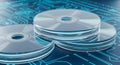 Three compact discs stacked on blue circuit board background with futuristic technology design and electronic components pattern Royalty Free Stock Photo