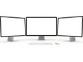Three computer monitors with a keyboard and mouse isolated on white background Royalty Free Stock Photo
