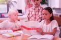 Three concentrated children learning chinese at school.