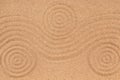 Three concentric circle and wave lines on the sand. Texture of sand. Royalty Free Stock Photo