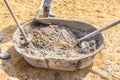 Three concrete workers mixing the cement and sand in salver, building construction site. Royalty Free Stock Photo