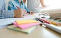 Three confident students doing homework together while sitting at the home Royalty Free Stock Photo