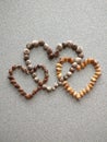 Three connected hearts created with snail shells collected at the beach of the atlantic ocean