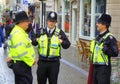 Three policemen talking in street