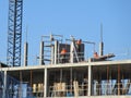 three construction workers working on a construction site. bricklayers