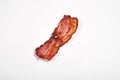 Three cooked, crispy fried bacon isolated on a white background. Royalty Free Stock Photo