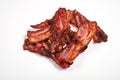 Three cooked, crispy fried bacon isolated on a white background. Royalty Free Stock Photo