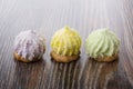 Three cookies with souffle and coconut flakes on table