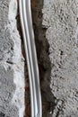 three-core electrical cable in a groove in a concrete wall Royalty Free Stock Photo